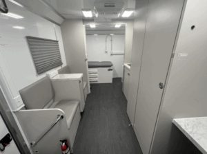 23 Ft Medical Mobile Clinic with private exam room, Grey Laminate for all cabinets and dividing walls White Marble Laminate for all countertops examining bed Exam Light - LED with Flexible Arm Blood Draw Chair in Front Room – BLACK Medical Fridge Replacing Standard and much more. (see detail exhibit).